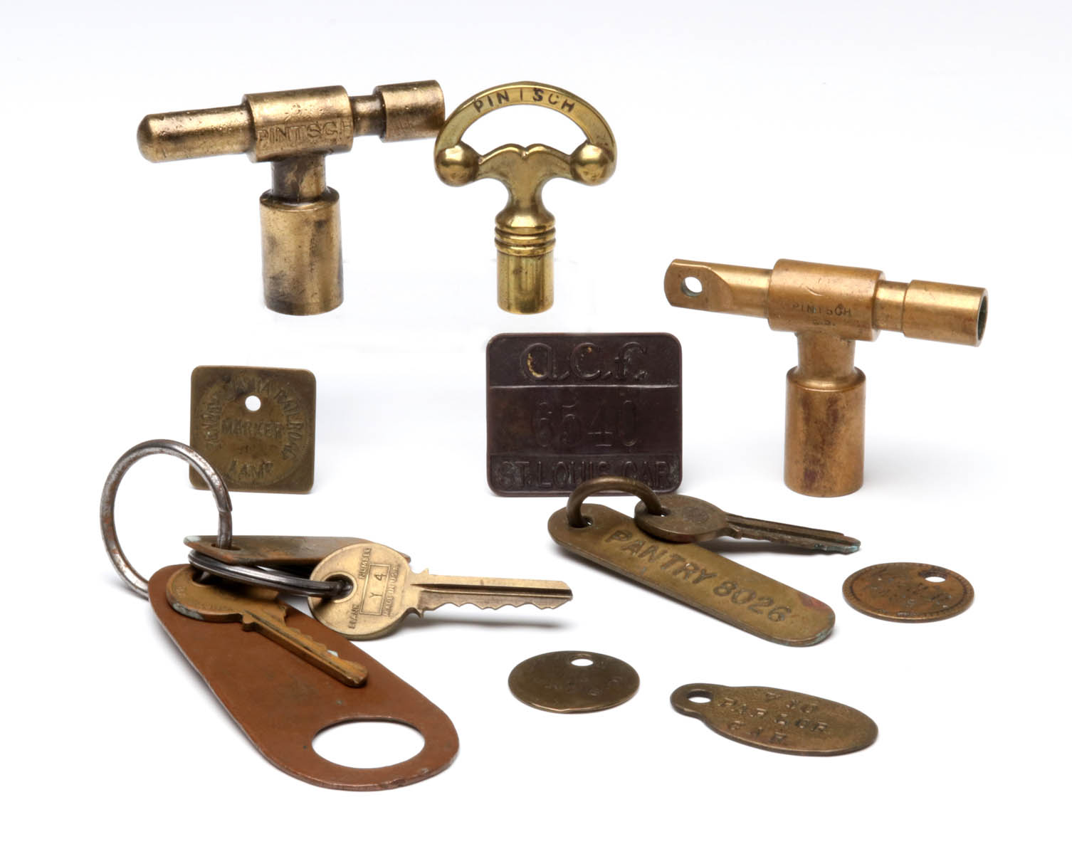 A COLLECTION OF RAILROAD KEYS AND TAGS