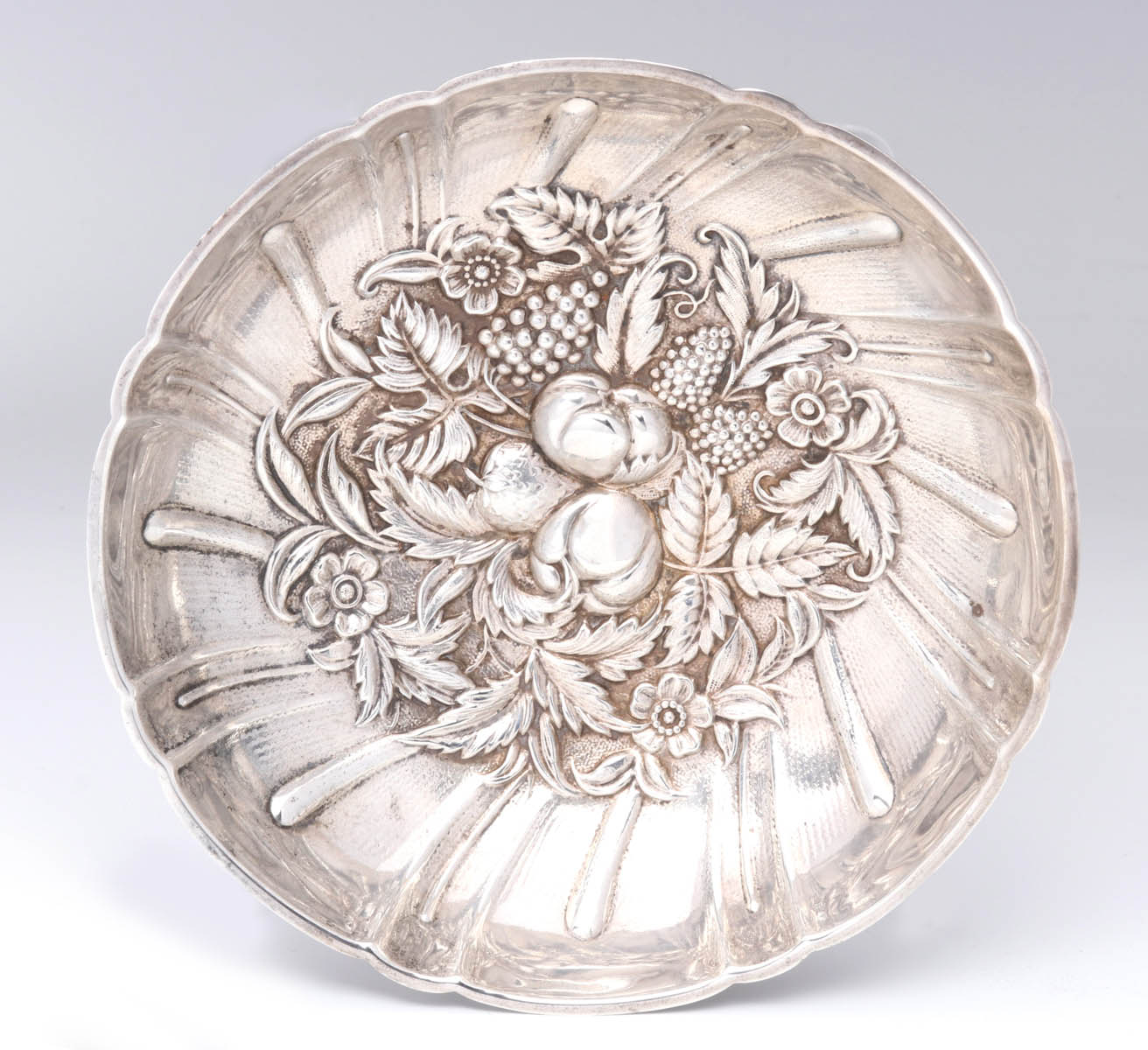 A KIRK REPOUSSE STERLING SILVER FOOTED DISH