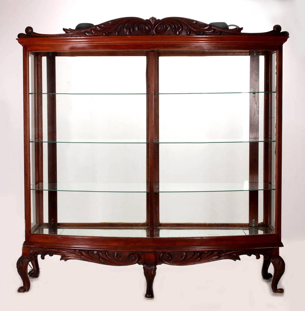 A LARGE EARLY 20THC BOW FRONT DISPLAY CASE ON LEGS