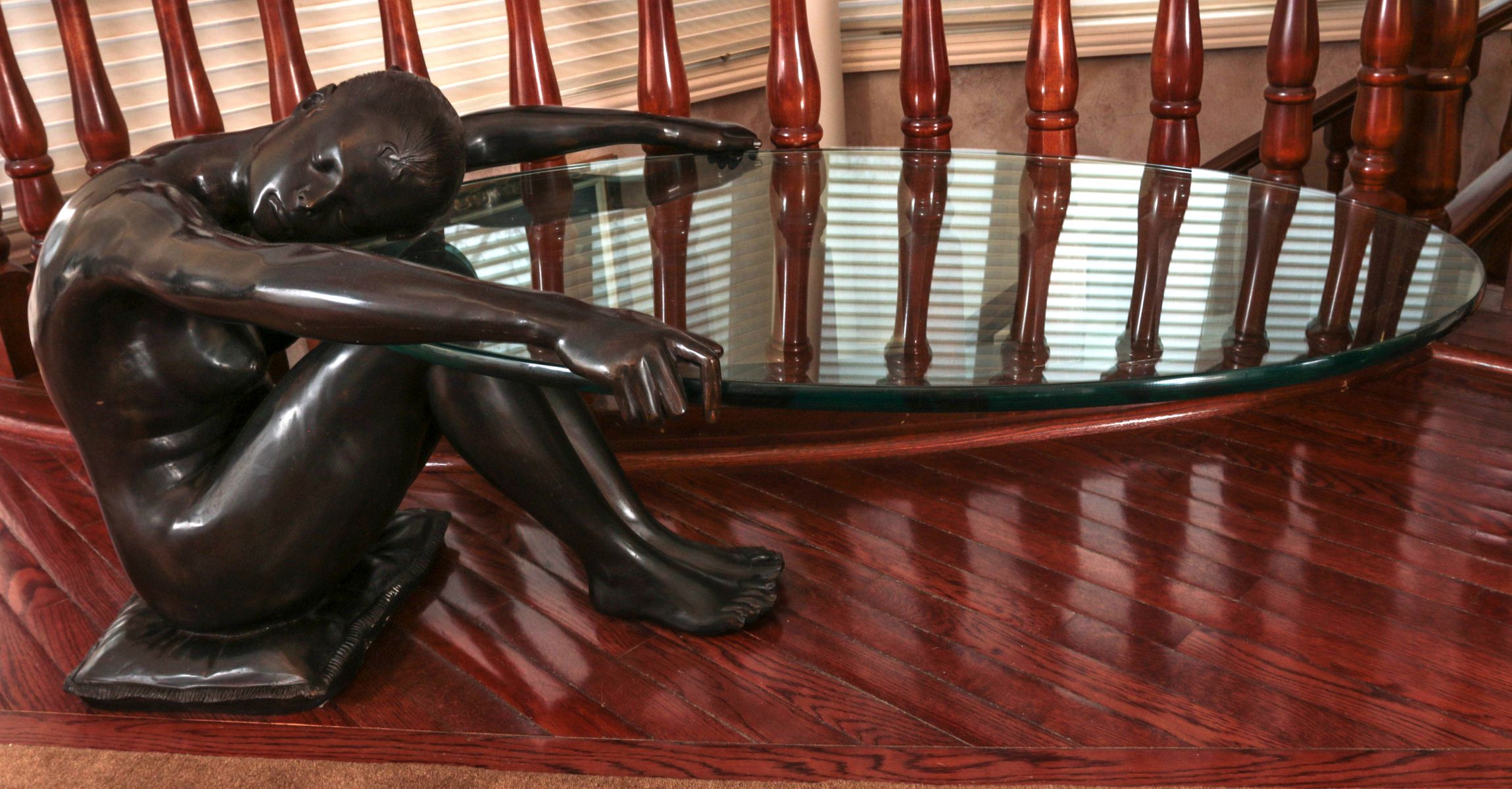 AN UNUSUAL BRONZE FEMALE NUDE CANTILEVERED TABLE