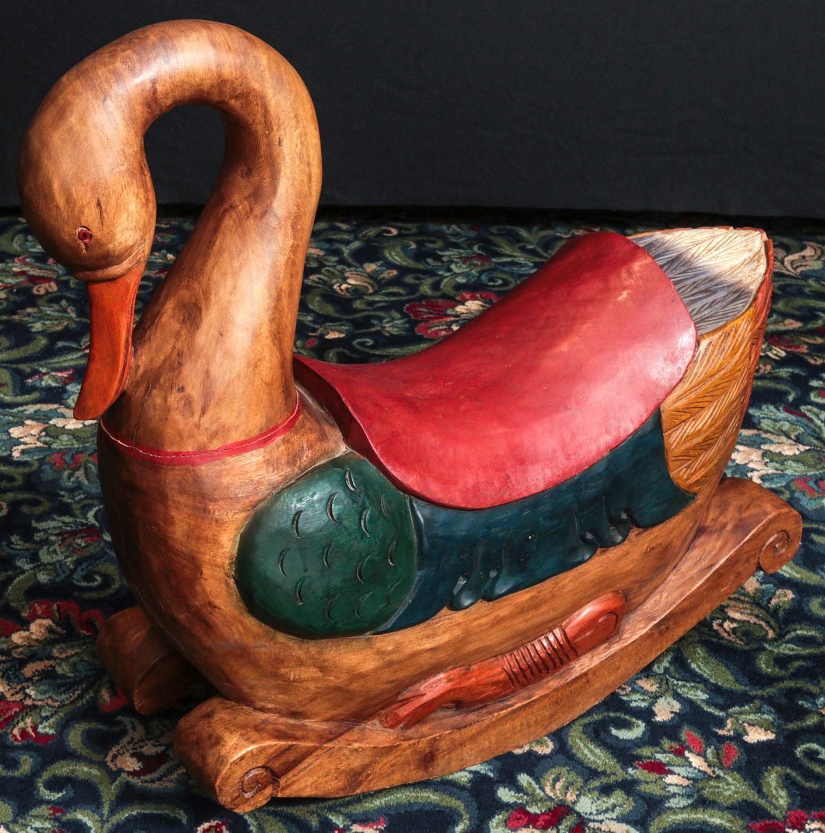 A CARVED AND PAINTED CHILD'S ROCKING RIDE-ON TOY