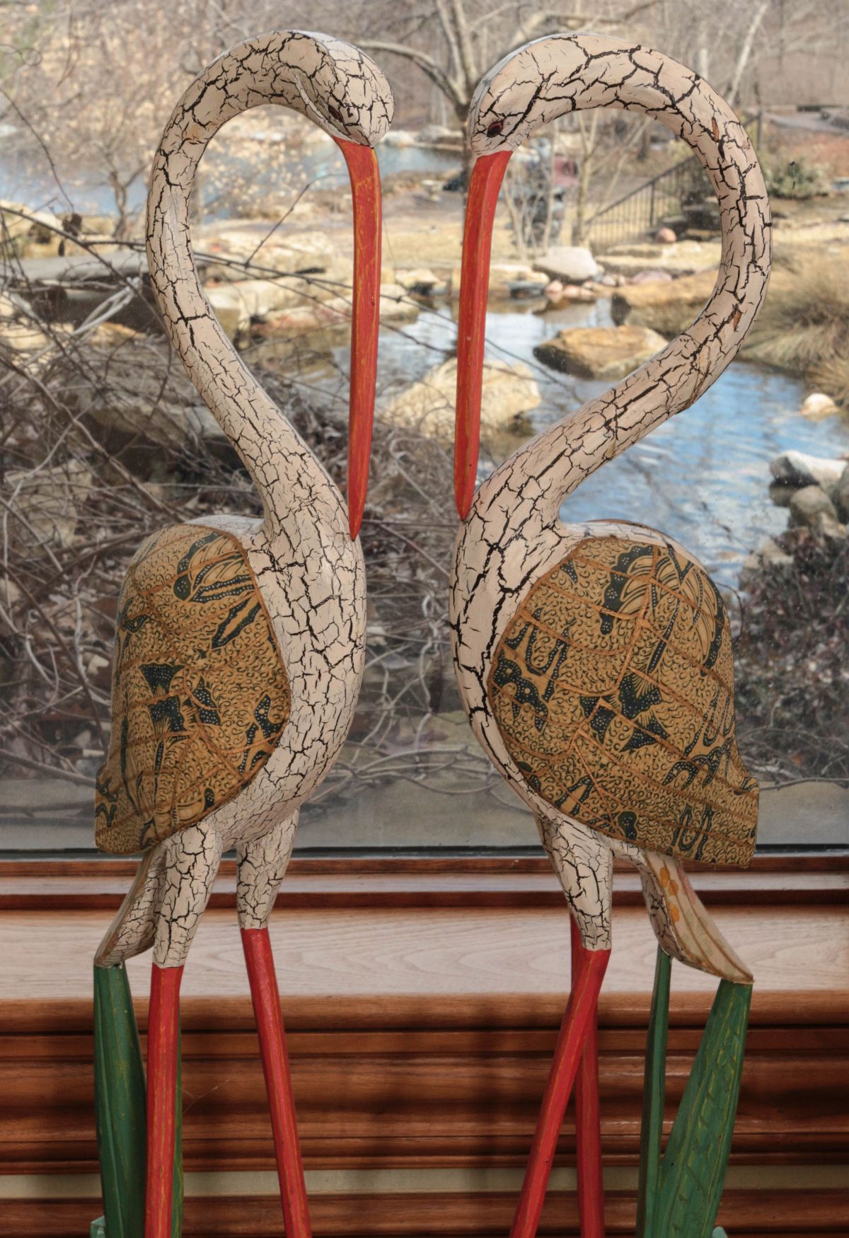 A PAIR OF PAINT DECORATED WOOD CARVINGS OF HERONS
