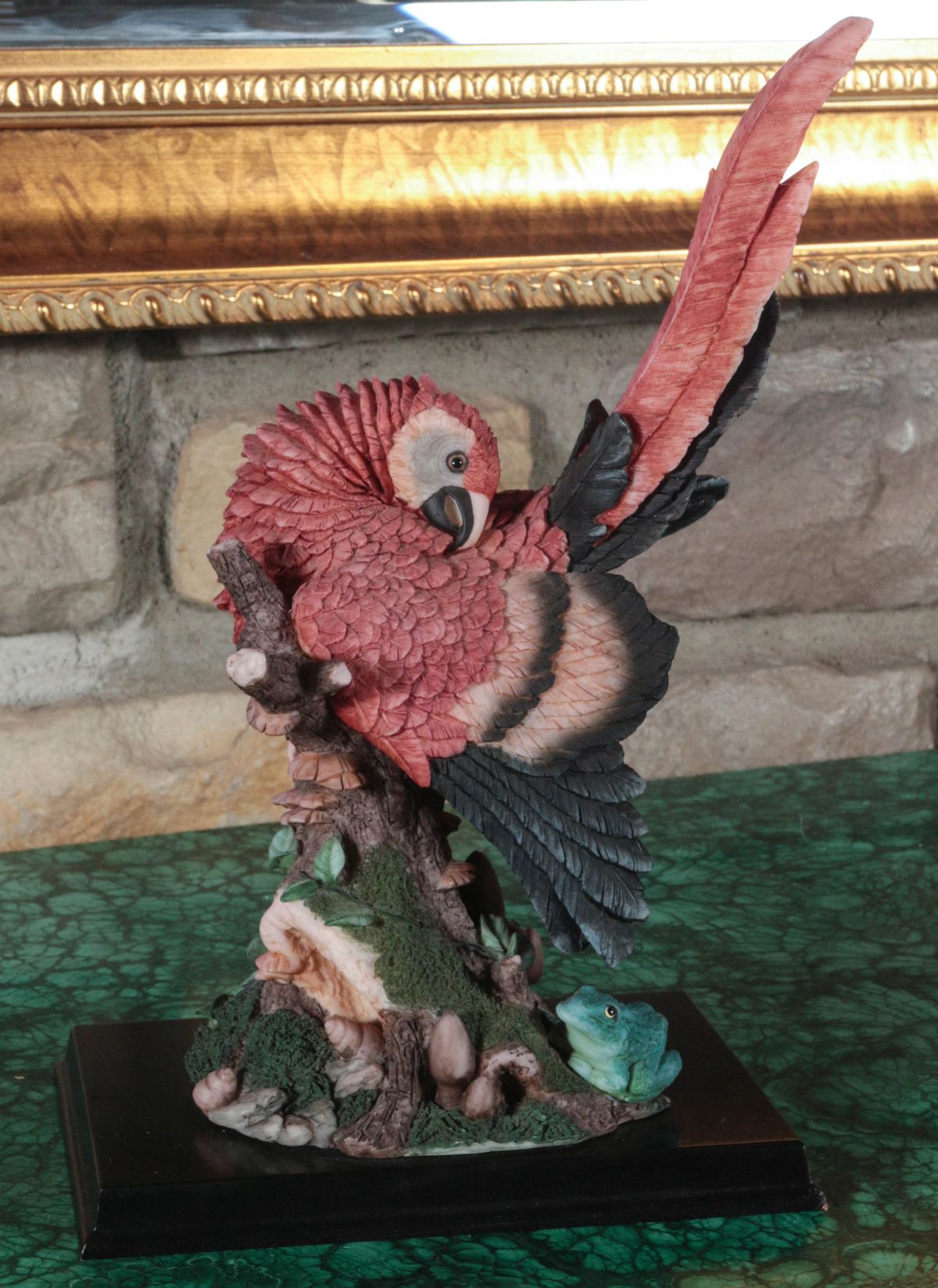 A POLYCHROME RESIN SCULPTURE OF A PARROT