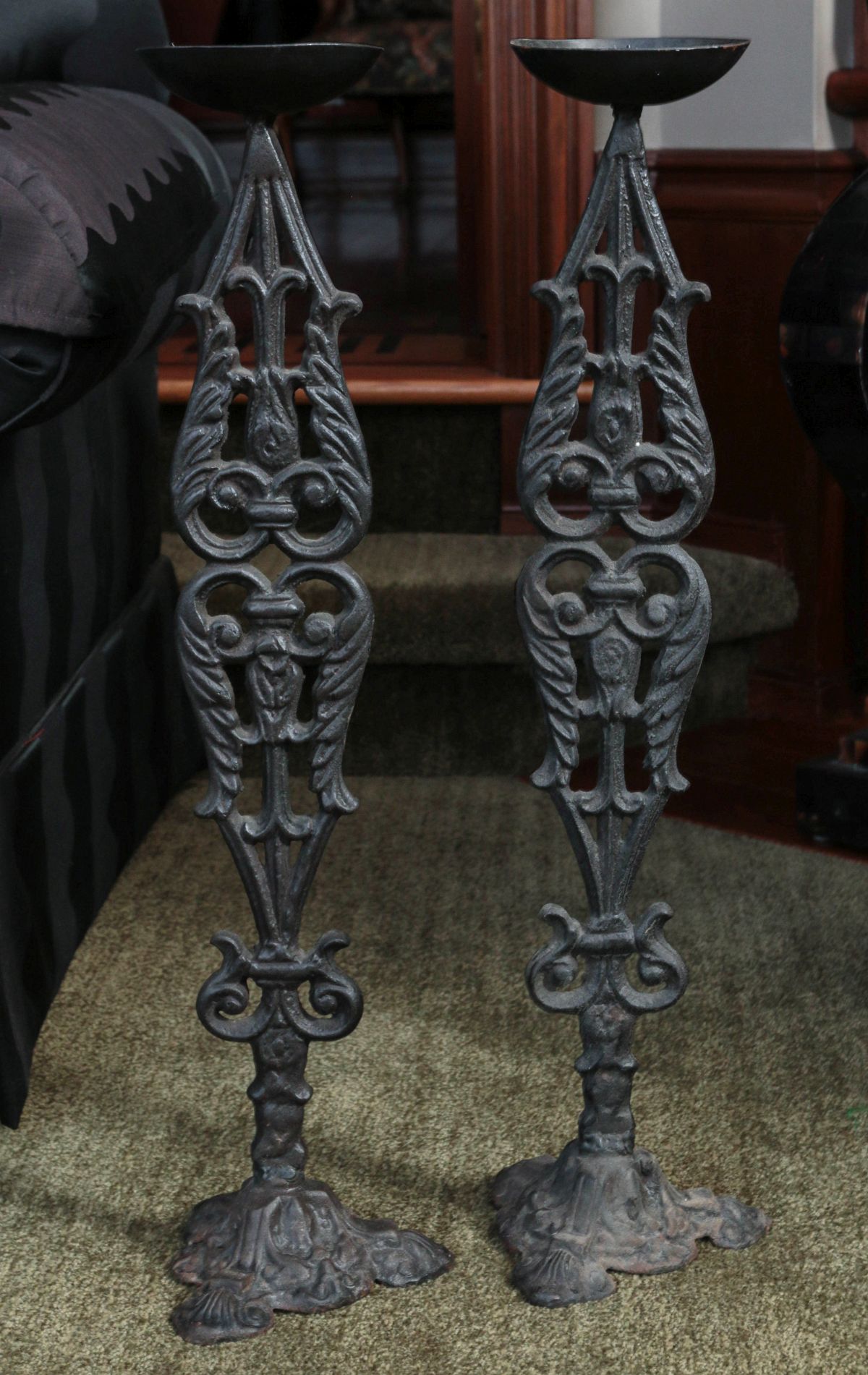 A PAIR OF CAST IRON CANDLE STANDS