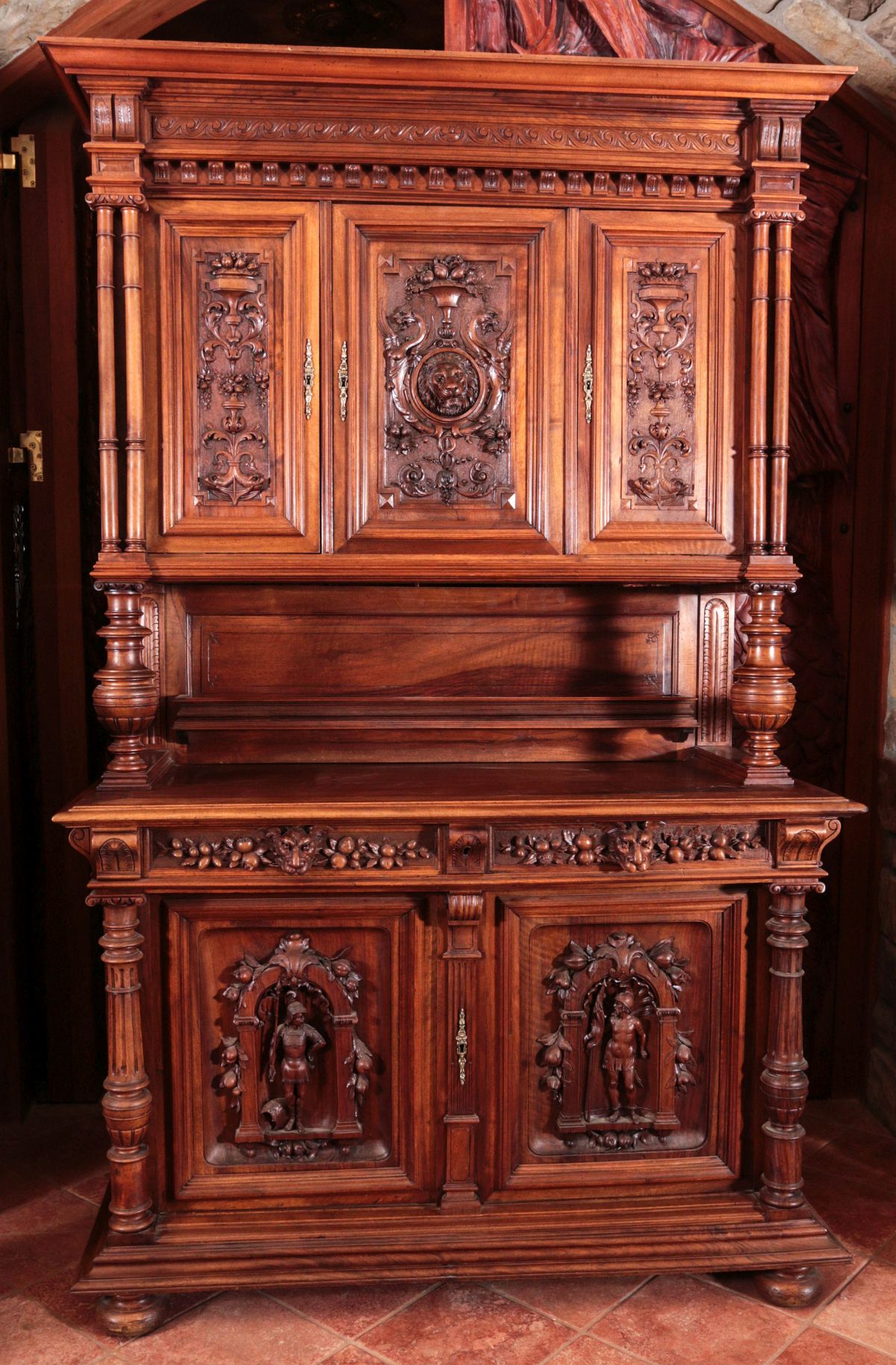 A LARGE HIGHLY CARVED CONTINENTAL WALNUT CABINET