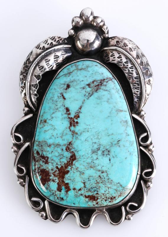 A NAVAJO STERLING AND TURQUOISE PENDANT