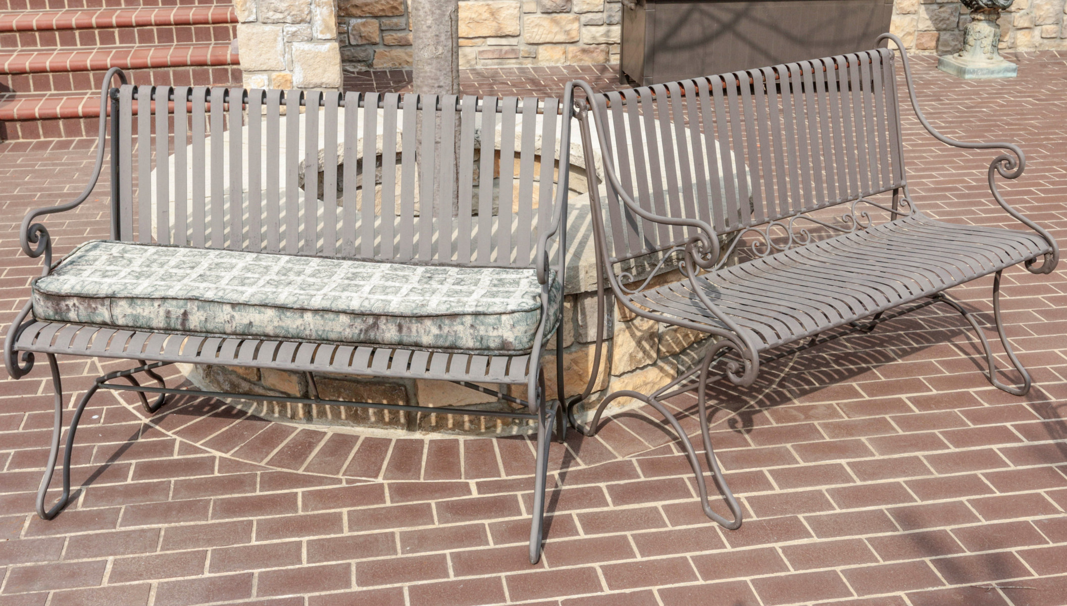 A PAIR OF STRAPWORK IRON PATIO BENCHES