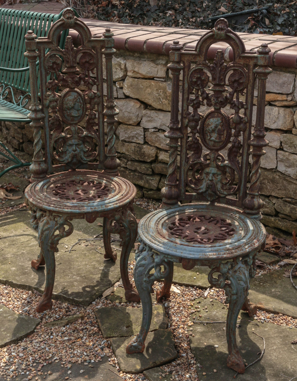 A PAIR OF GOTHIC REVIVAL STYLE IRON GARDEN CHAIRS