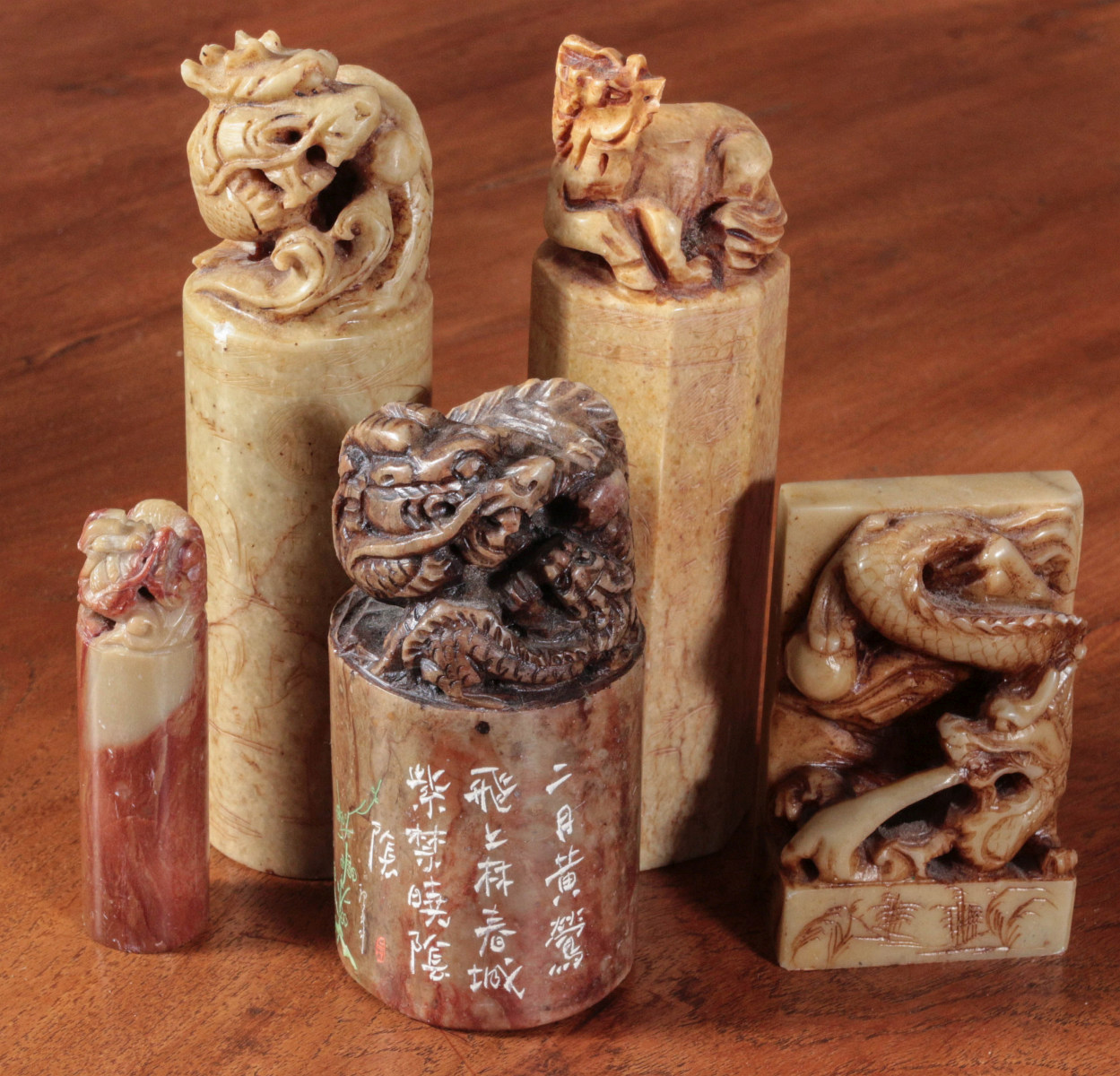FIVE CARVED STONE SEALS WITH FIGURAL SURMOUNTS