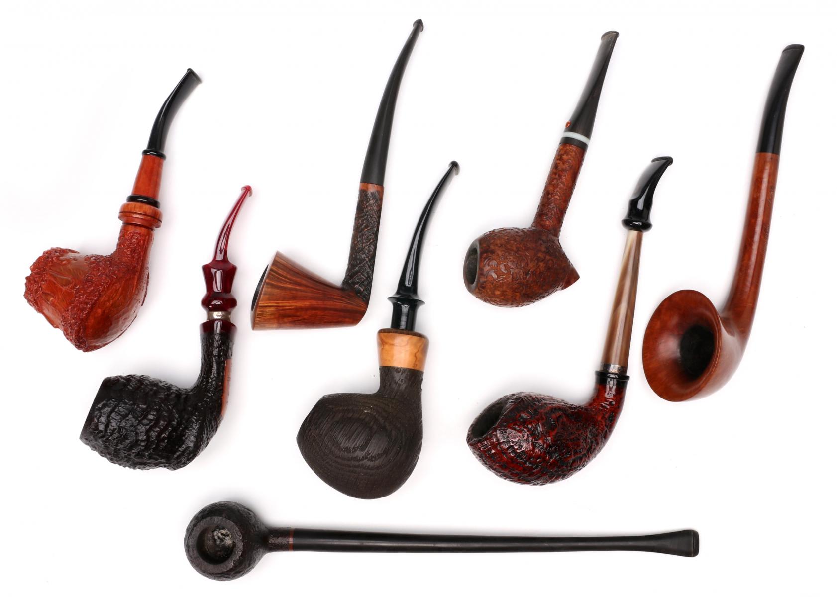 A COLLECTION OF EXOTIC HAND CARVED SMOKING PIPES