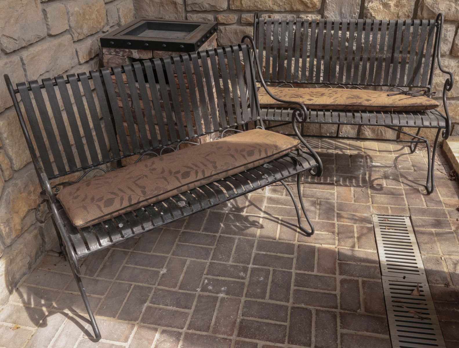 A PAIR OF STRAPWORK IRON PATIO BENCHES