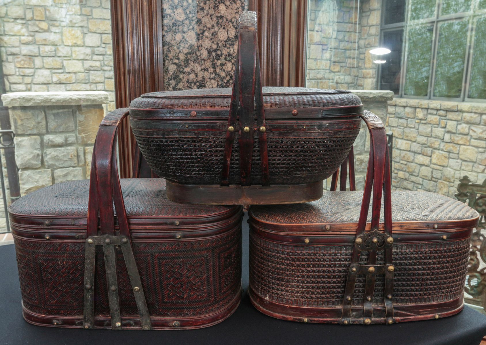 THREE ASIAN BASKETRY CONTAINERS WITH HANDLES