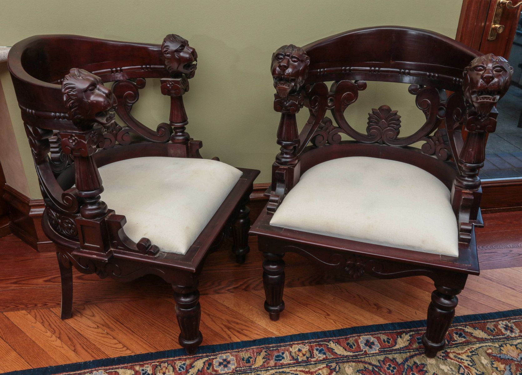 A PAIR CARVED CHAIRS WITH LARGE LION'S HEADS