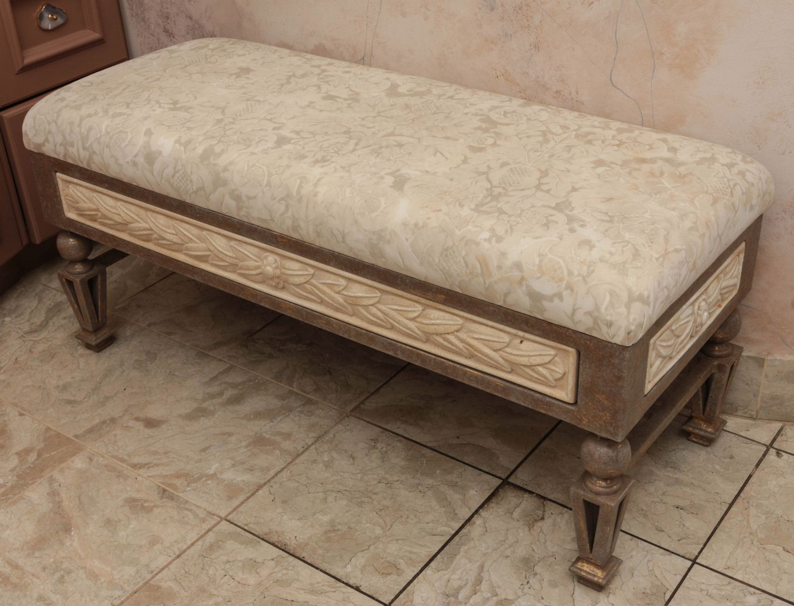 AN IRON BASE DRESSING ROOM BENCH WITH PADDED SEAT