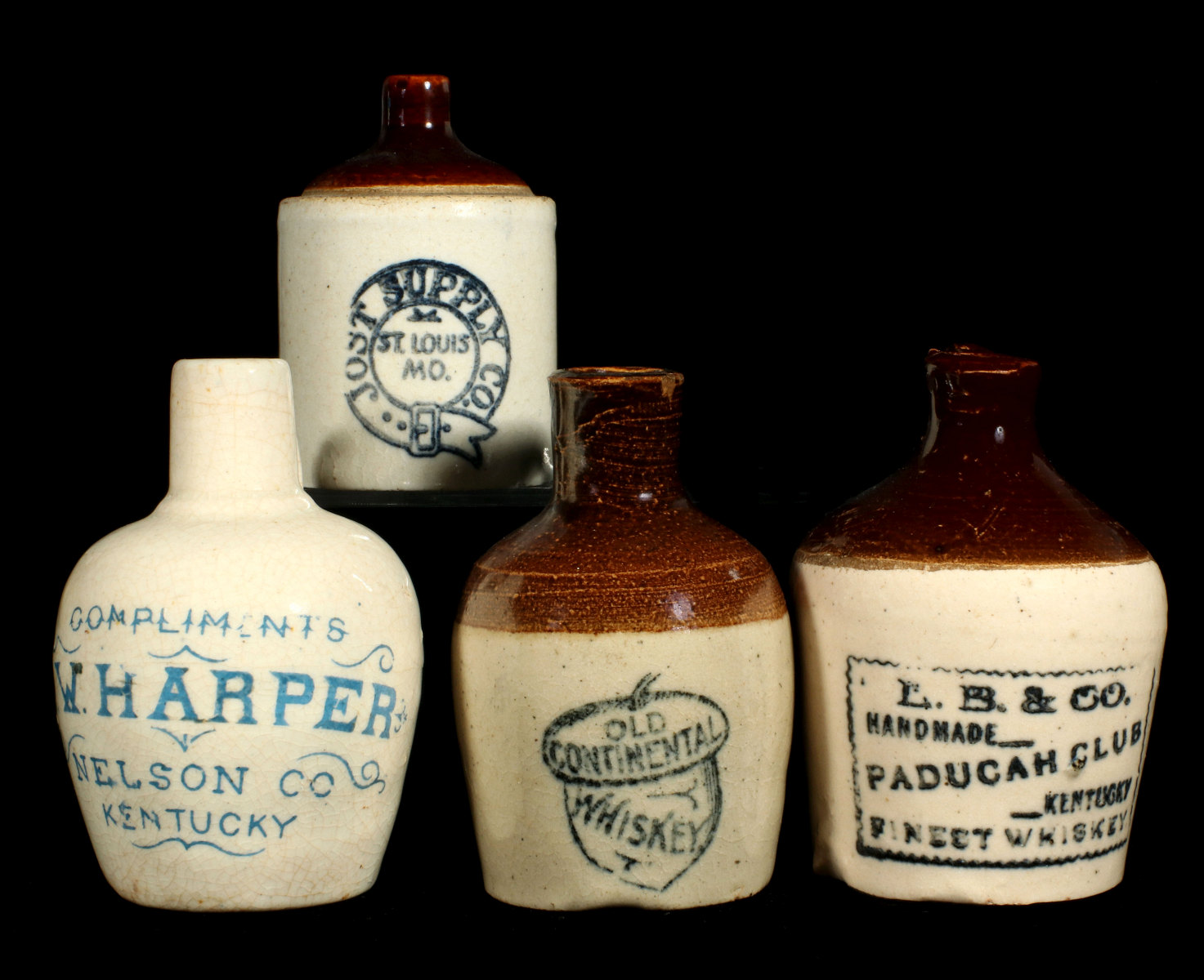 A COLLECTION OF FOUR STONEWARE ADVERTISING MINI JUGS