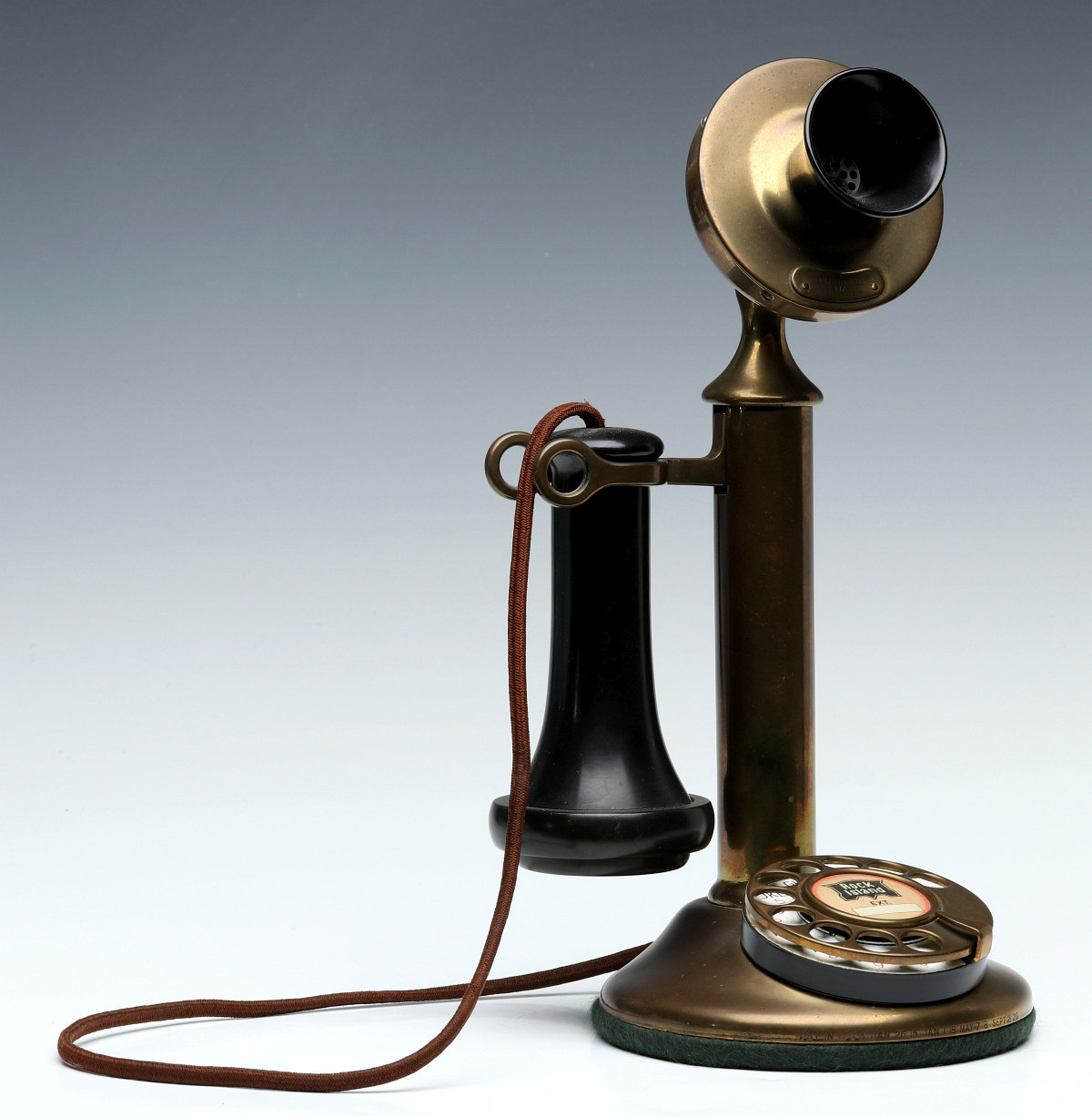 A CANDLESTICK TELEPHONE WITH ROCK ISLAND LINES BADGE