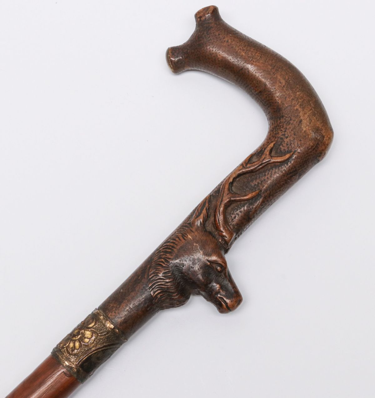 AN ANTIQUE CROOK HANDLE CANE WITH CARVED STAG HEAD