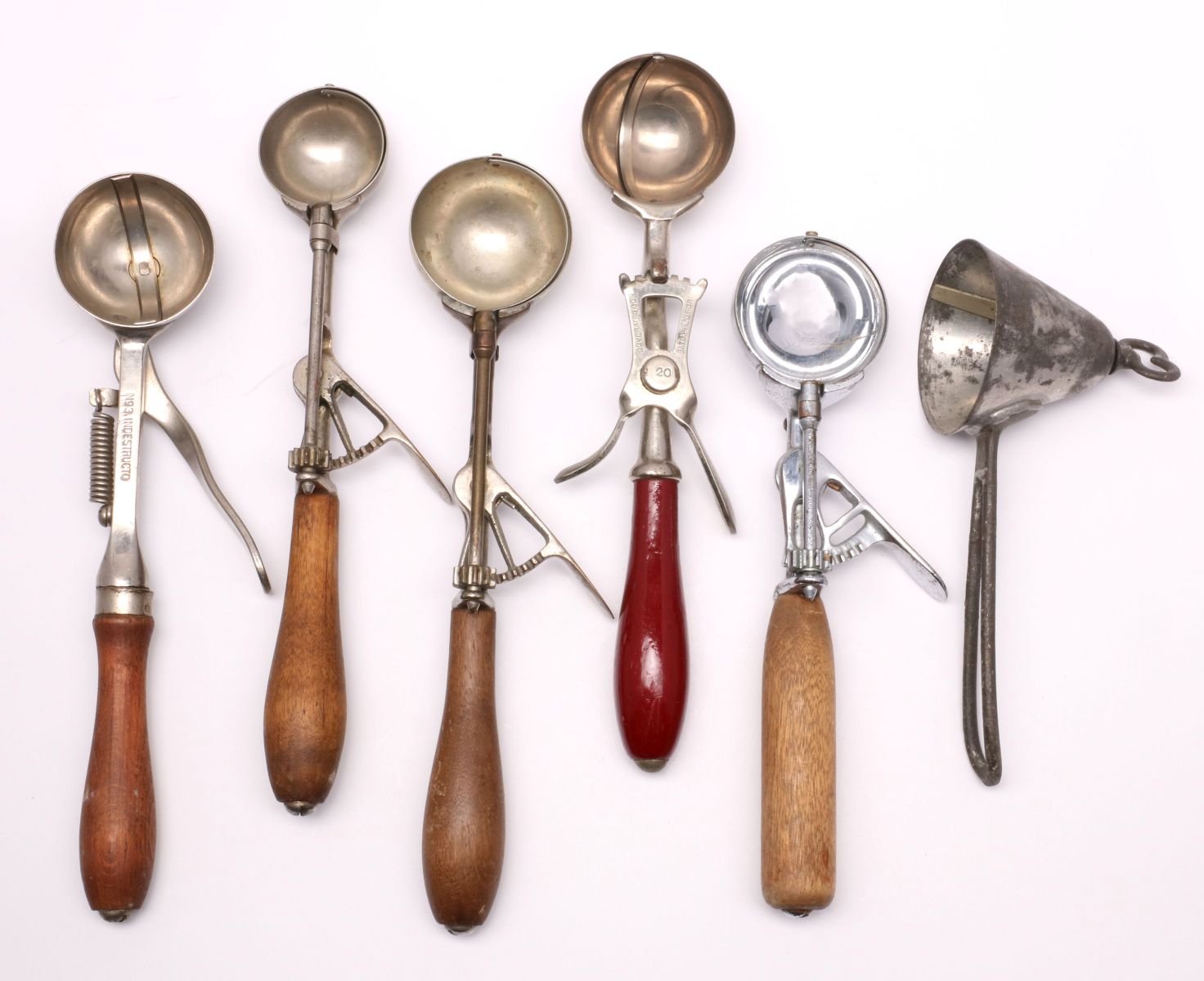 A COLLECTION OF ANTIQUE ICE CREAM SCOOPS