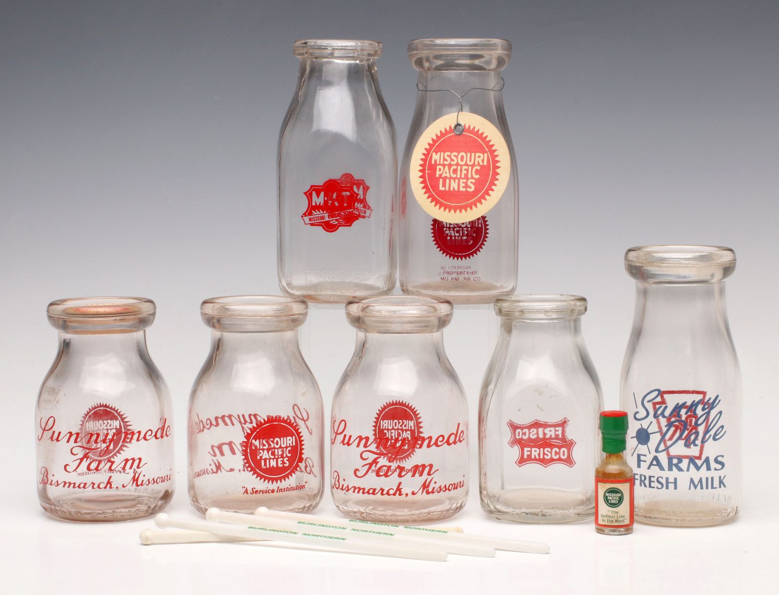 A COLLECTION OF RAILROAD ADVERTISING MILK BOTTLES