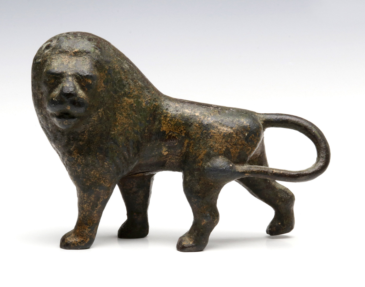 LARGE CAST FIGURE OF A LION; THREE CAST IRON FROGS
