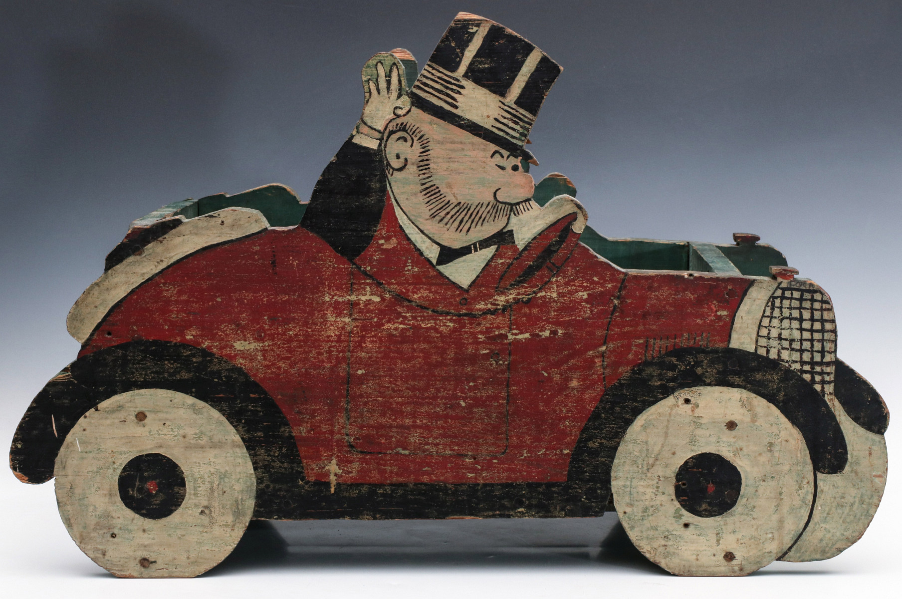A 1930s FOLK ART PAINTED WOOD JEFF IN TOURING CAR
