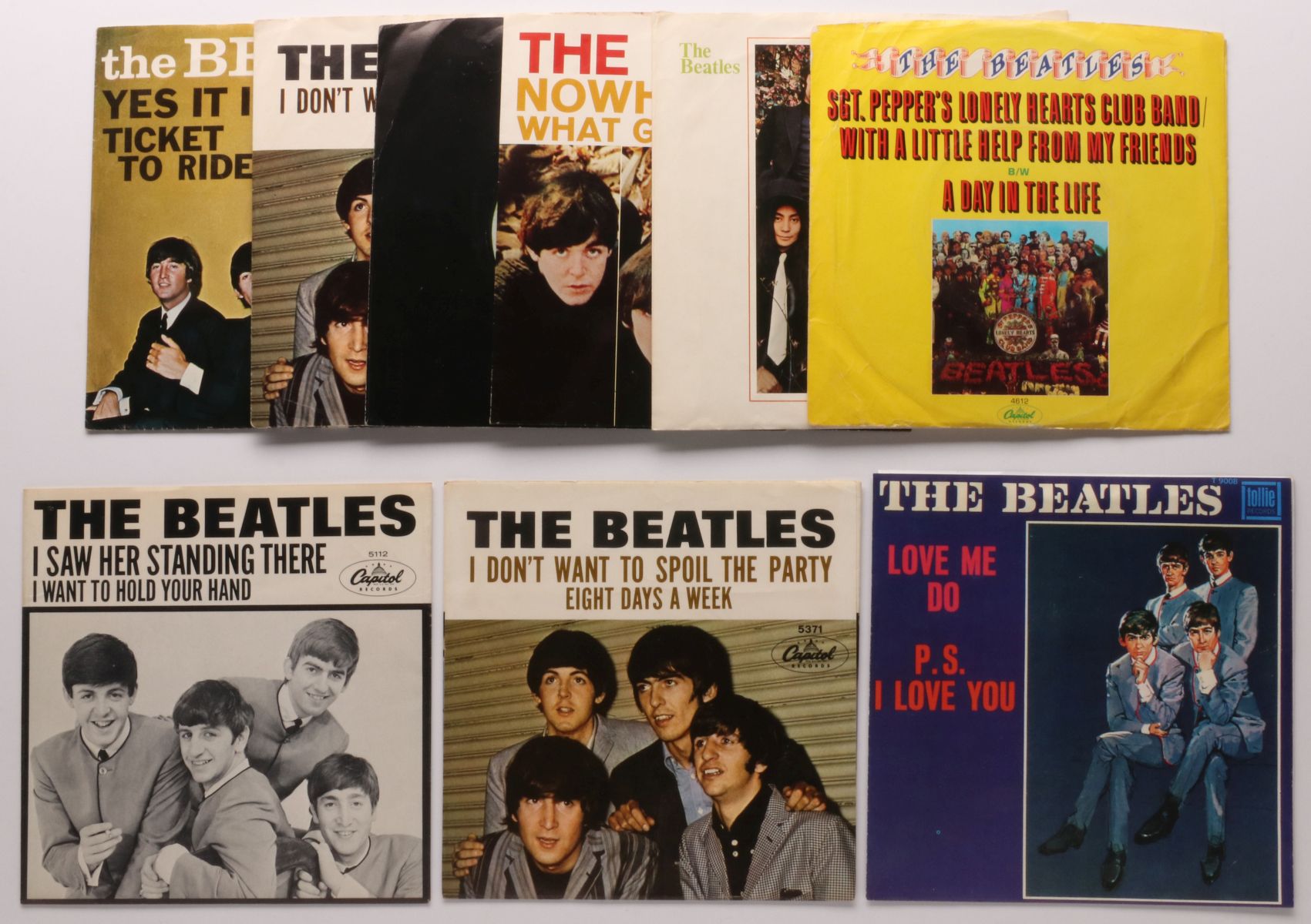 A COLLECTION OF BEATLES 45 RPM RECORDS AND SLEEVES