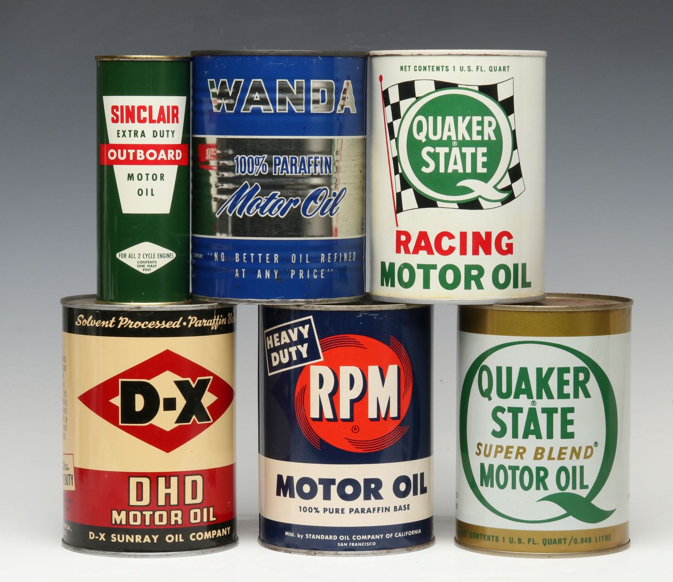A GROUP OF VINTAGE MOTOR OIL CANS WITH ADVERTISING