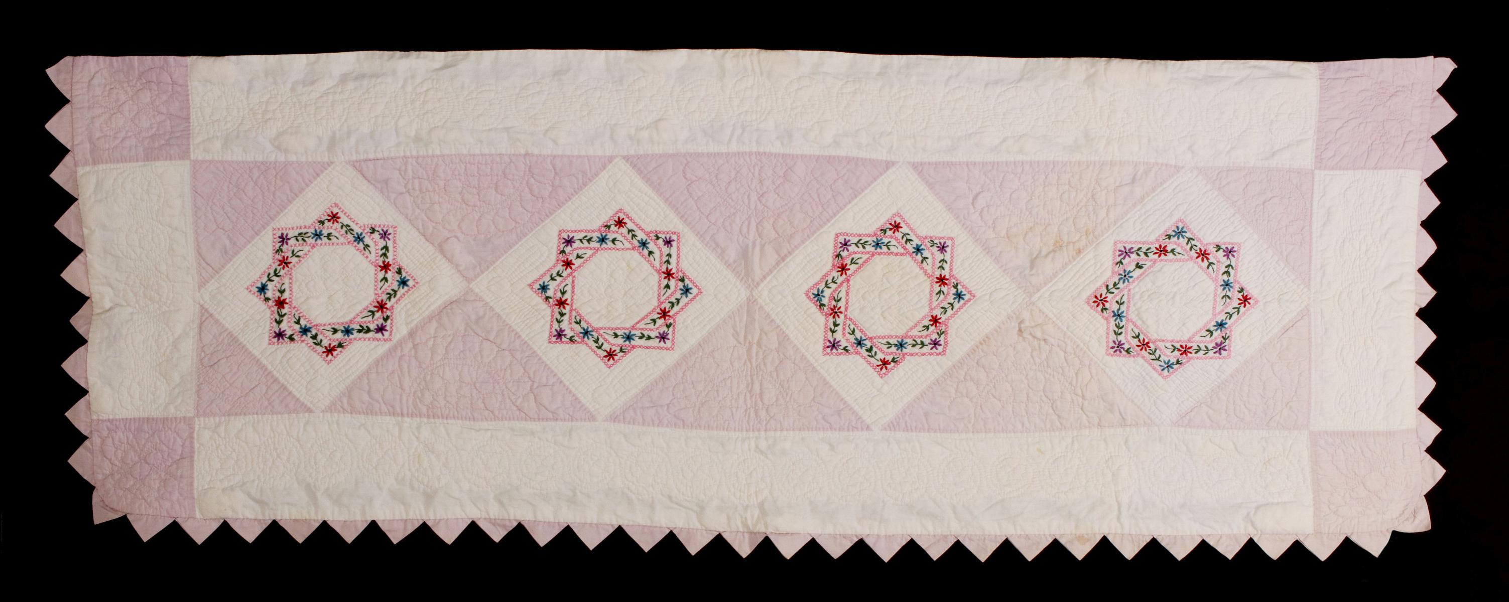 A VINTAGE QUILTED AND EMBROIDERED PILLOW SHAM