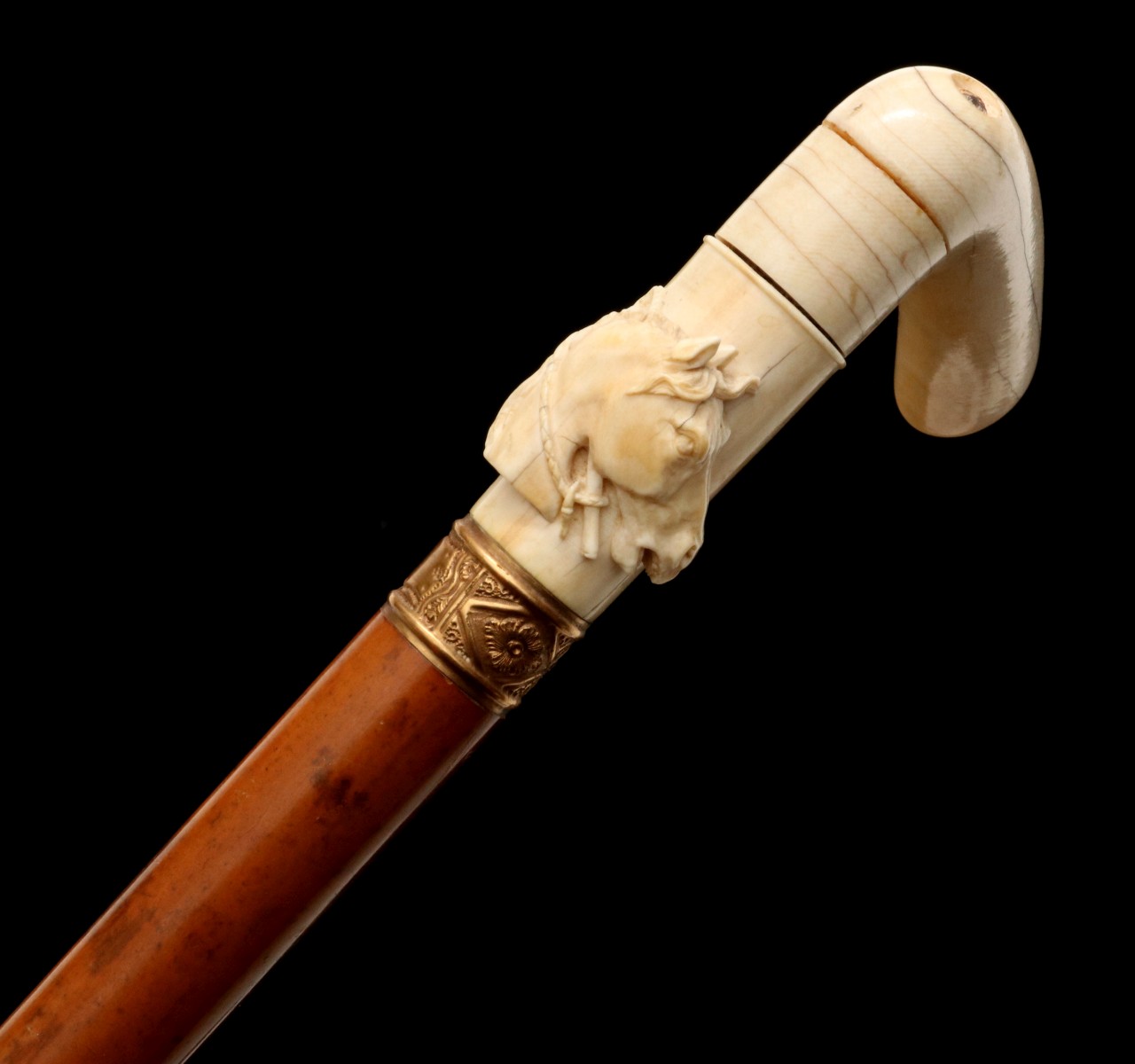 A 19TH CENTURY CROOK HANDLE CANE WITH CARVED HORSE HEAD