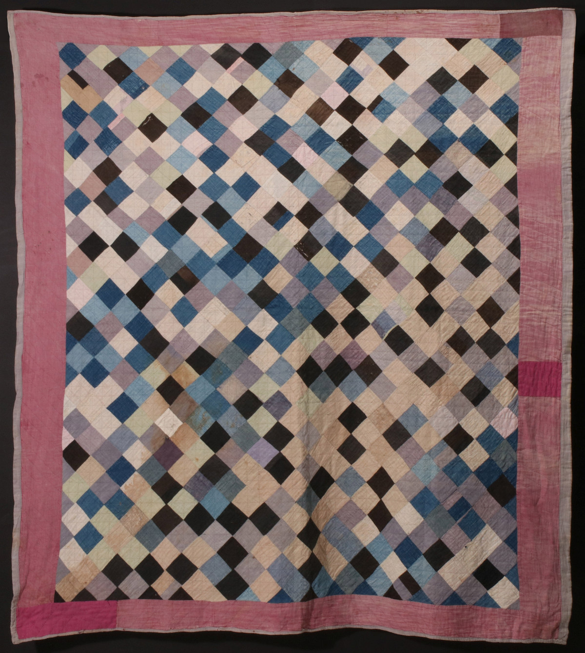 AN ANTIQUE AMISH POSTAGE STAMP PATCHWORK QUILT