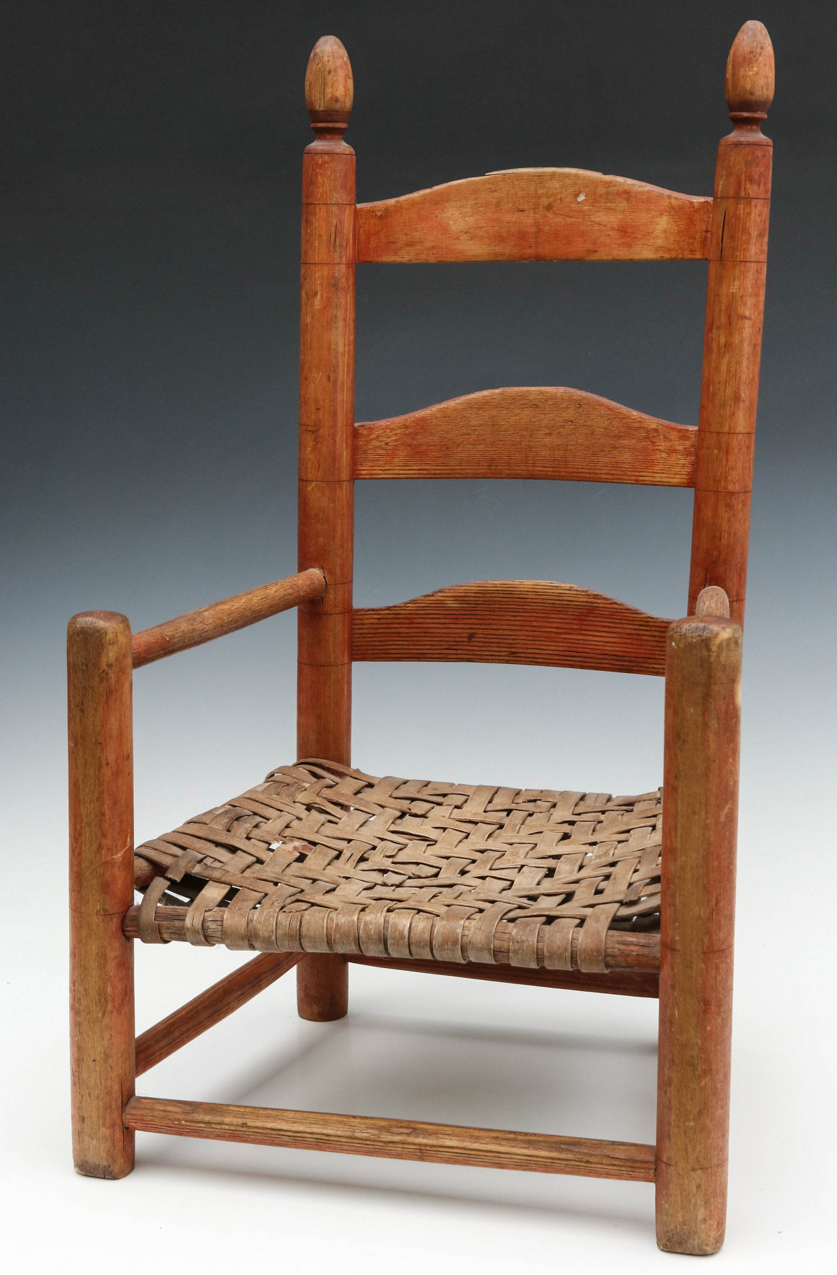 AN EARLY AMERICAN LADDER BACK CHILD'S CHAIR WITH STAIN