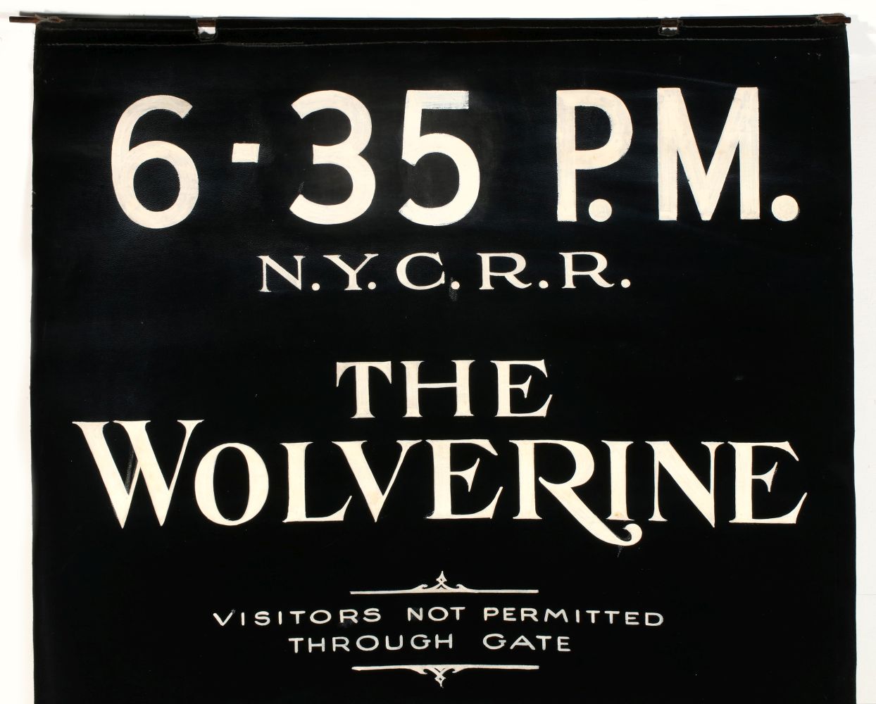 A PAINTED GATE SIGN FOR N.Y.C.R.R. 'THE WOLVERINE'