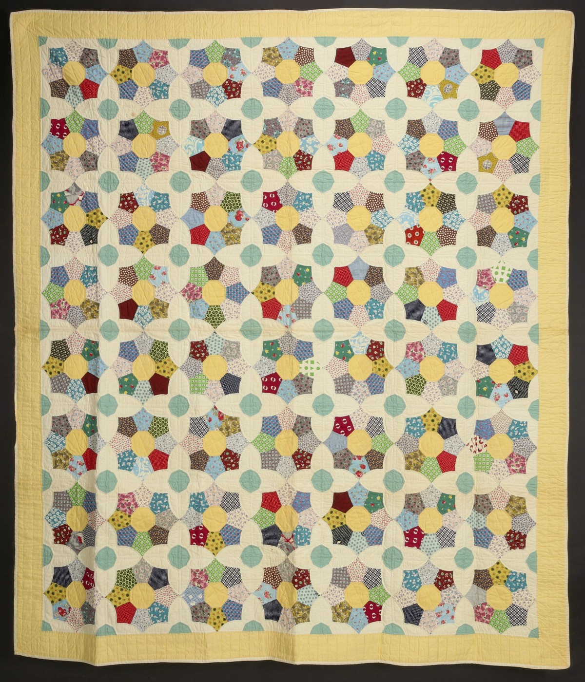 A 1930s FEEDSACK QUILT WITH INTERESTING FAN BLOCKS