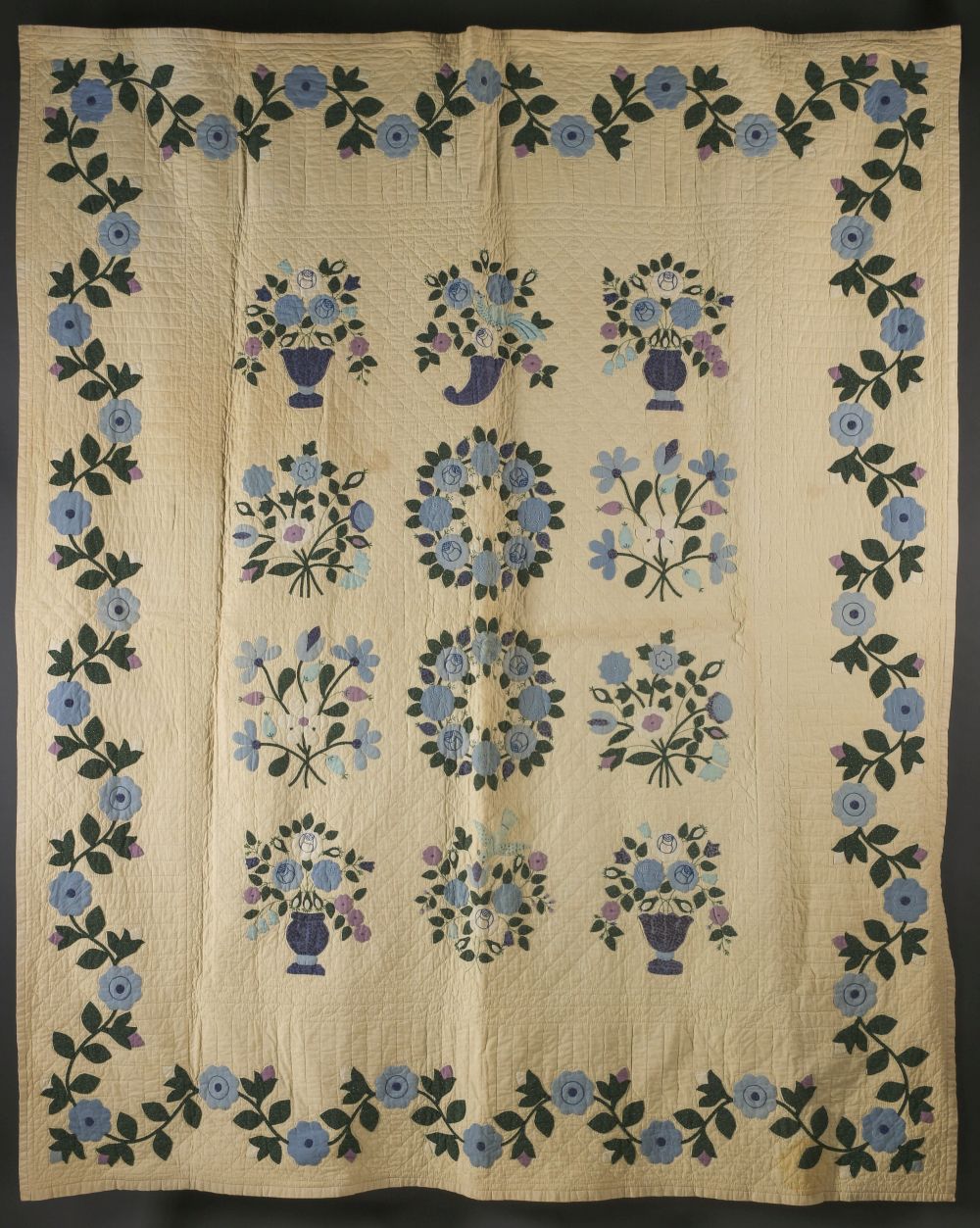 AN ELABORATE APPLIQUE' QUILT OF FLORAL SPRAYS AND VASES