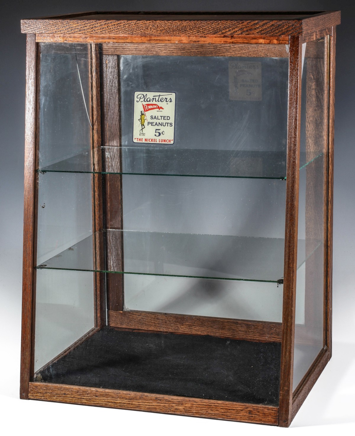 AN EARLY 20TH CENTURY SHOWCASE WITH PLANTER'S DECAL