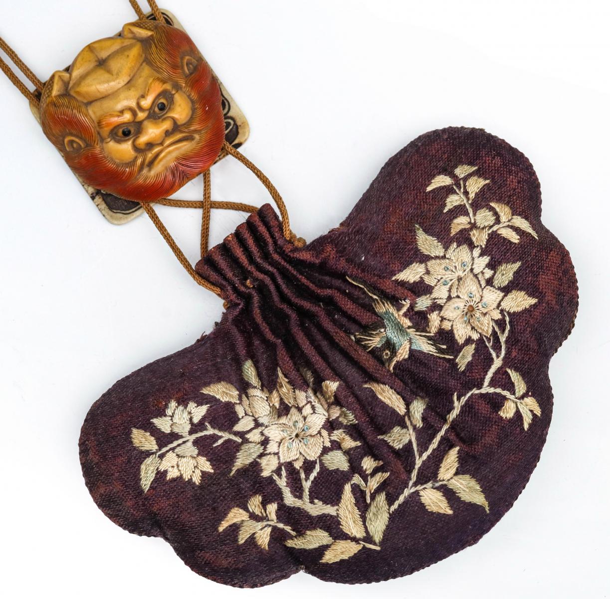 A JAPANESE EMBROIDERED PURSE WITH MYTHICAL MASK SLIDE