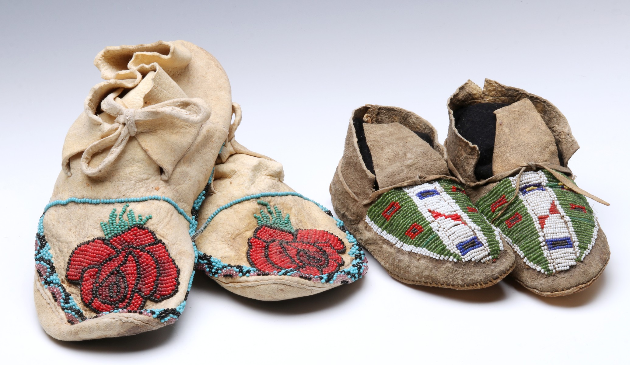 A PAIR SINEW SEWN PLAINS BEADED CHILDREN'S MOCCASINS