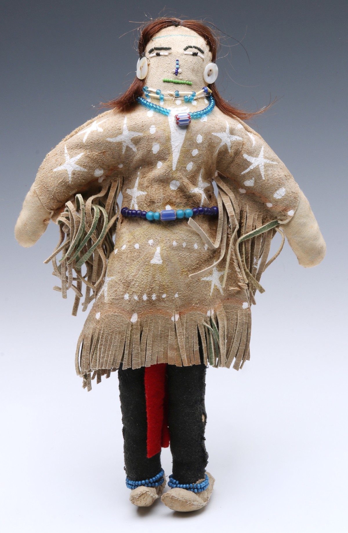A HIDE AND CLOTH DOLL IN THE NATIVE AMERICAN STYLE