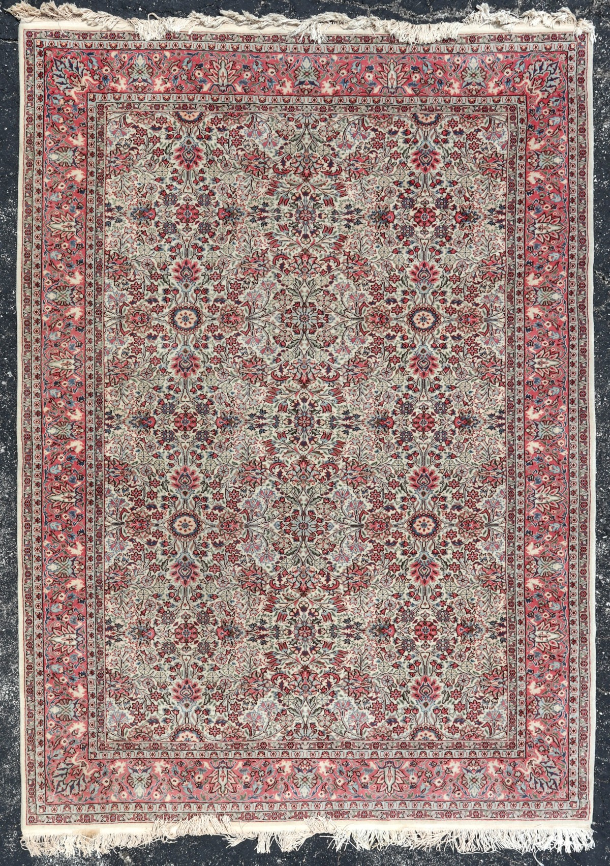 A HAND MADE ROOM-SIZED INDO PERSIAN RUG
