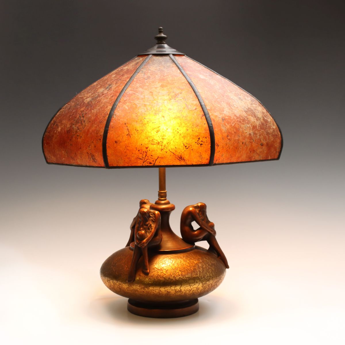 A POTTERY LAMP WITH NUDE FIGURES SIGNED OLIVE KOOKEN