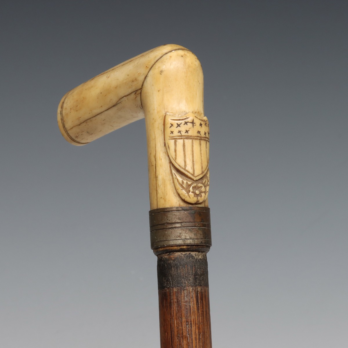 A 19TH C. BONE HANDLE CANE WITH CARVED FEDERAL SHIELD