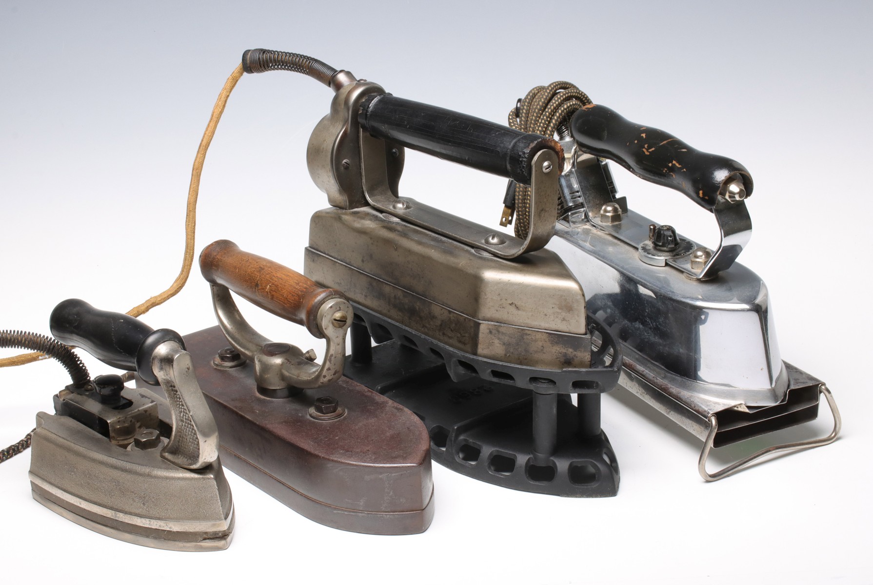 FOUR ELECTRIC IRONS, CIRCA EARLY 20TH CENTURY