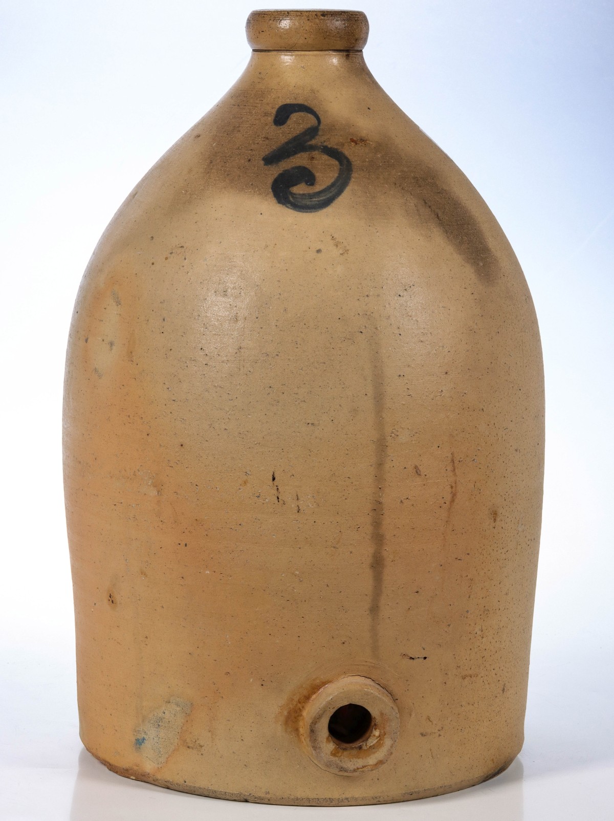 AN UNUSUAL STONEWARE CONTAINER WITH PIERCED DRAIN BASE