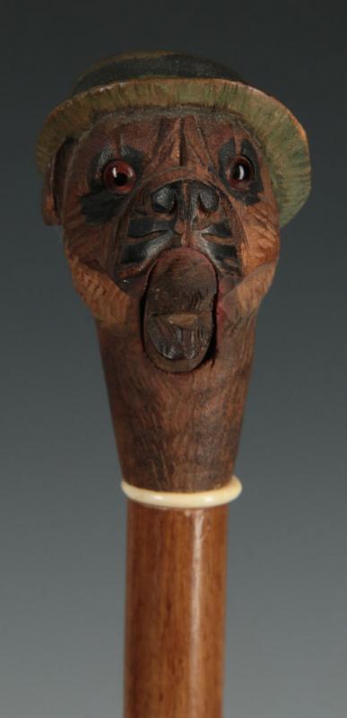AN ANTIQUE SWAGGER STICK WITH BLACK FOREST DOG'S HEAD 