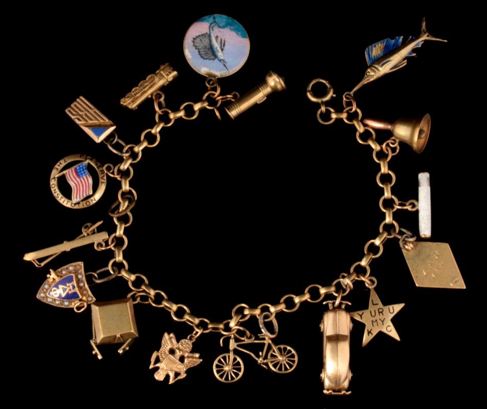 A 14K GOLD CHARM BRACELET WITH SIXTEEN CHARMS