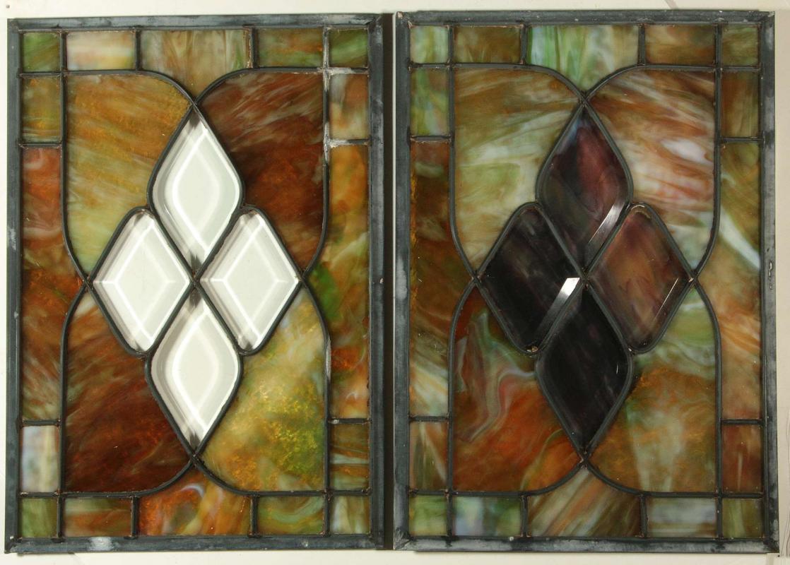 A NEAR PAIR OF STAINED AND LEADED GLASS PANELS