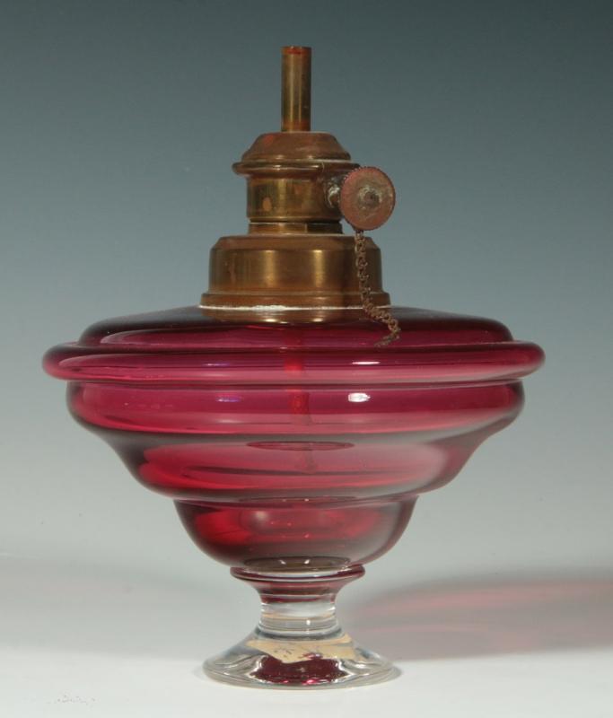 AN UNUSUAL CRANBERRY GLASS WHALE OIL LAMP