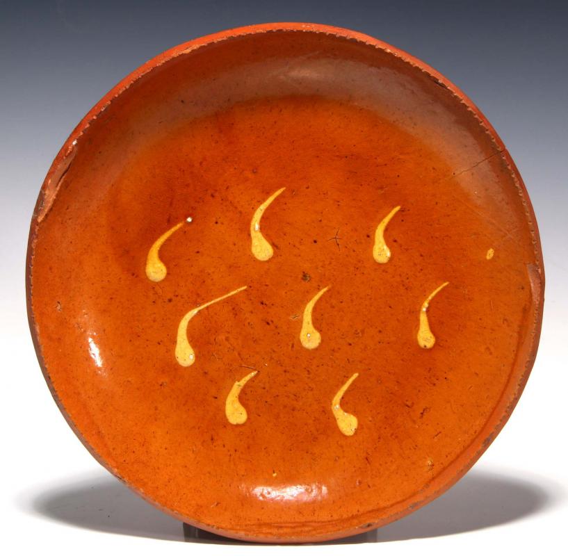 A SLIP DECORATED 19TH CENTURY REDWARE PLATE 