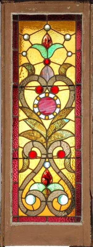 A 19TH CENTURY STAINED AND JEWELED GLASS WINDOW