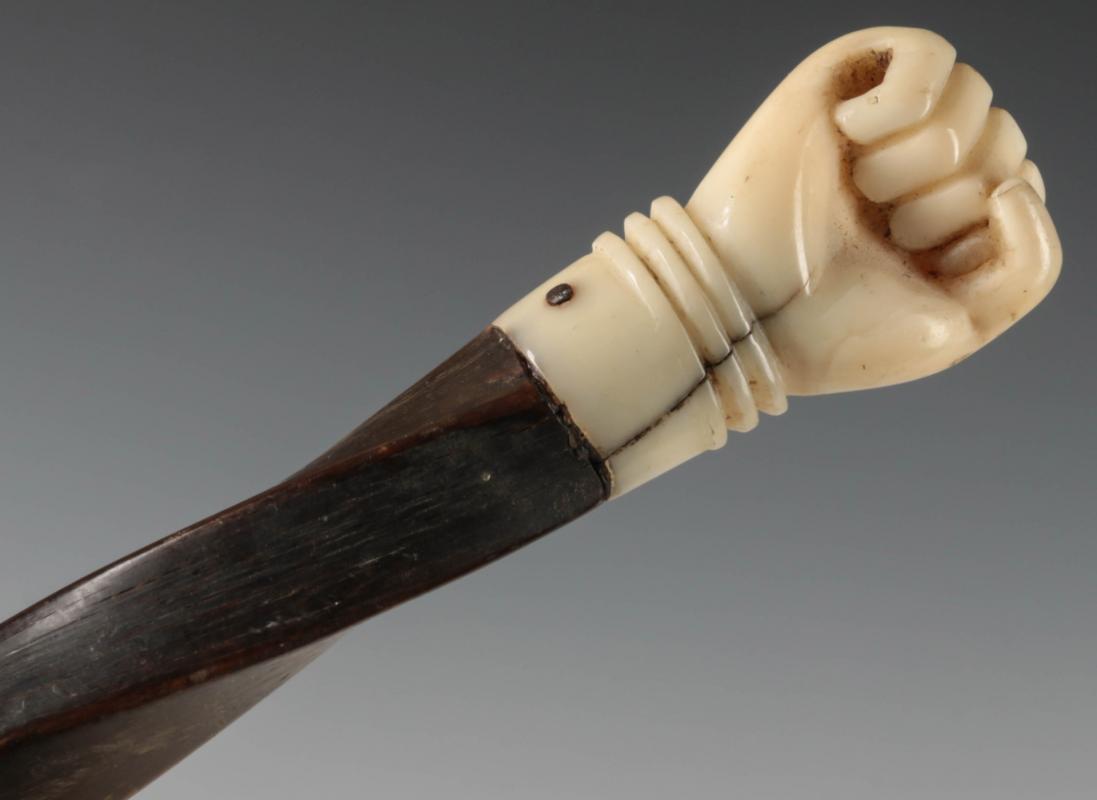 A 19C BALEEN WALKING STICK WITH CARVED FIST HANDLE